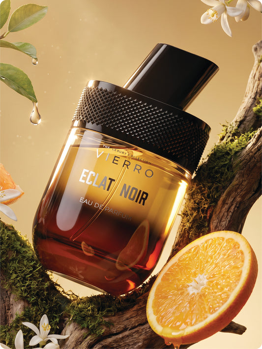 Vierro Eclat Noir perfume bottle with orange and floral elements on a natural background b