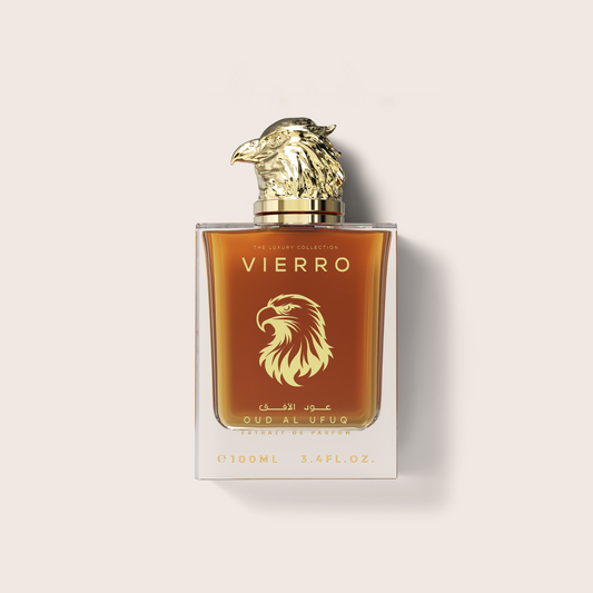 A 100ml glass bottle of Vierro Oud Al Ufuq perfume featuring a detailed gold falcon head cap and warm amber liquid inside, set against a neutral light background.